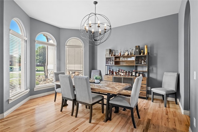 dining room featuring light hardwood / wood-style flooring and an inviting chandelier