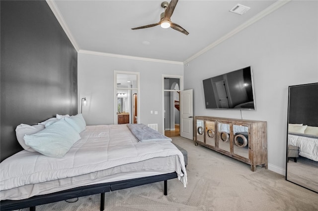 bedroom with ceiling fan, light colored carpet, ensuite bathroom, and crown molding