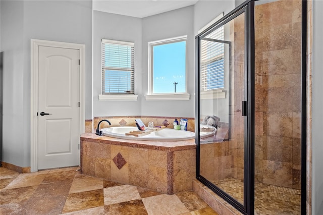 bathroom featuring shower with separate bathtub and a wealth of natural light