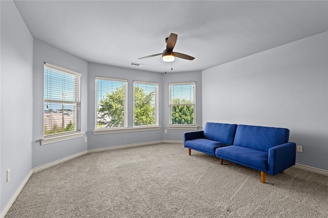 living area featuring carpet flooring and ceiling fan