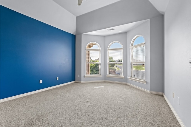 carpeted empty room featuring ceiling fan