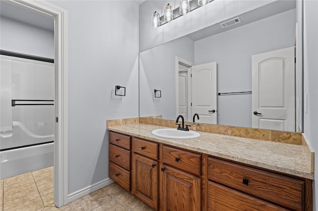 bathroom with tile patterned floors, vanity, and  shower combination