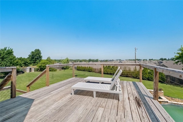 wooden terrace with a lawn