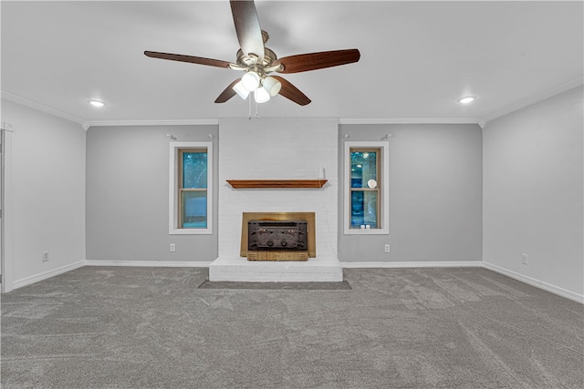 unfurnished living room featuring ceiling fan, a fireplace, crown molding, and carpet floors