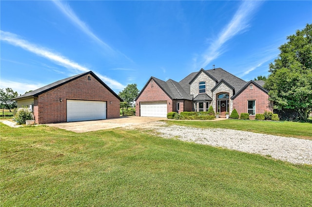 french country home with a garage and a front yard