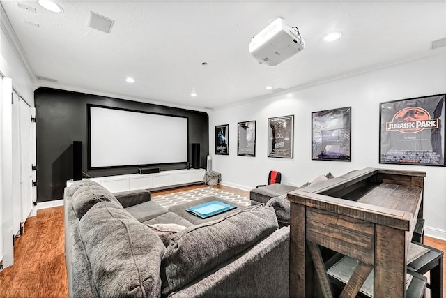cinema with crown molding, wood finished floors, and recessed lighting