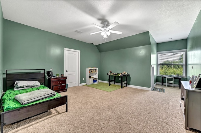 bedroom with ceiling fan, a textured ceiling, lofted ceiling, and light carpet