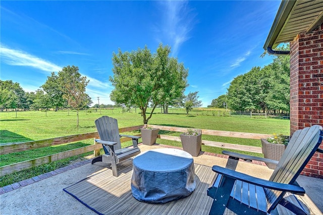 view of patio featuring a wooden deck, fence, and a rural view