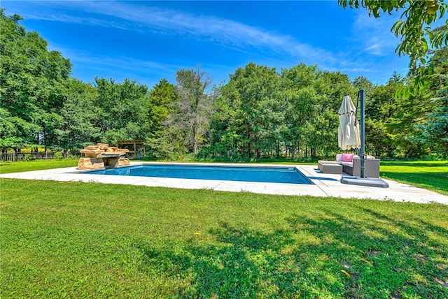 view of swimming pool featuring a lawn and a patio