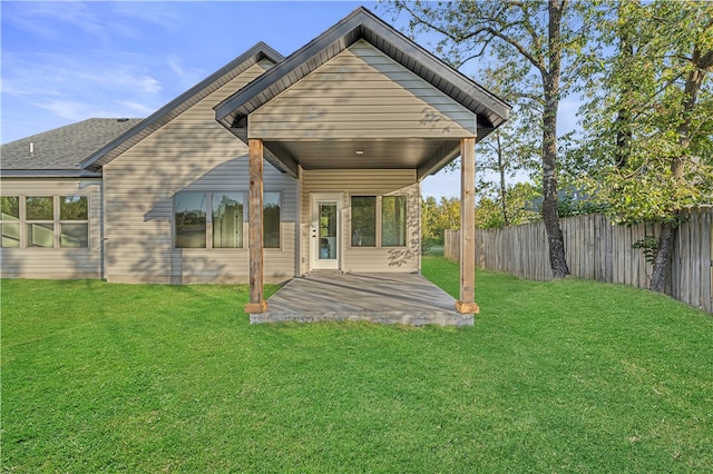 rear view of property with a lawn and a patio