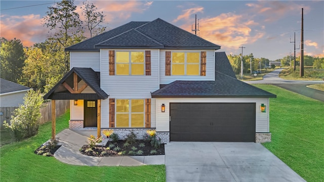 view of front facade featuring a lawn and a garage