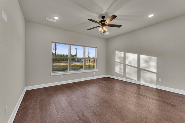 unfurnished room featuring ceiling fan and dark wood-type flooring