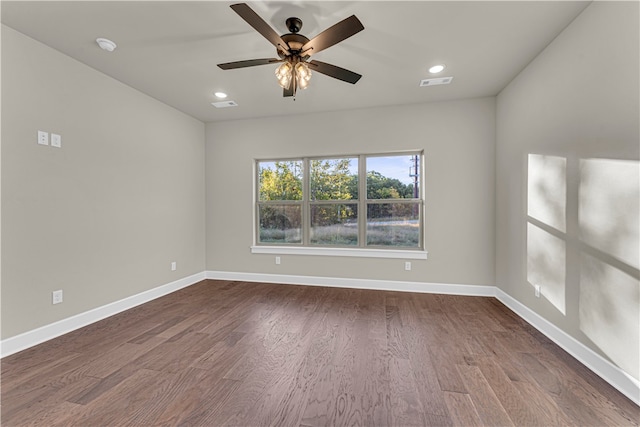 unfurnished room with ceiling fan and dark hardwood / wood-style flooring