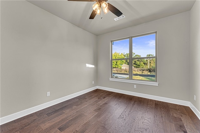 spare room with dark hardwood / wood-style flooring and ceiling fan