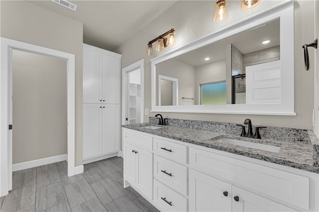 bathroom with a shower and vanity