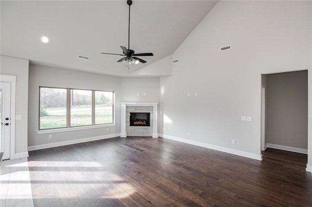 unfurnished living room featuring high vaulted ceiling, ceiling fan, baseboards, and visible vents