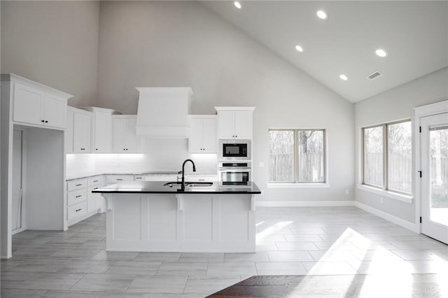 kitchen with visible vents, recessed lighting, stainless steel oven, and high vaulted ceiling