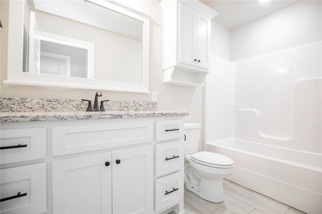 bathroom with vanity, toilet, and tub / shower combination