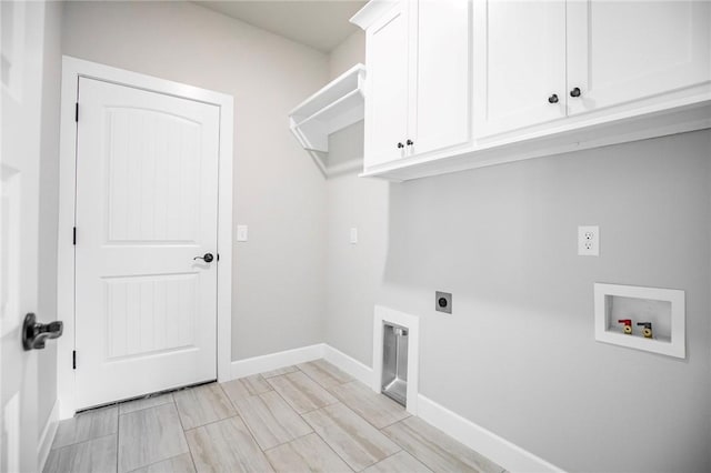 laundry room featuring washer hookup, baseboards, electric dryer hookup, and cabinet space