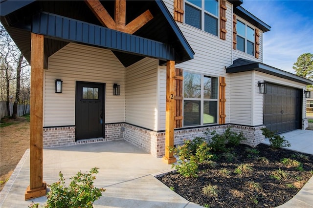 view of front of property with an attached garage, driveway, and brick siding