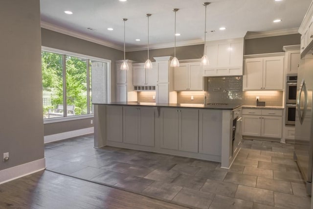 kitchen with backsplash, white cabinetry, and pendant lighting