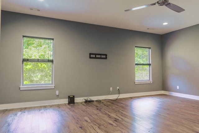 empty room with hardwood / wood-style flooring and ceiling fan