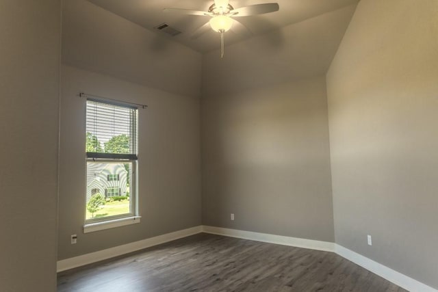 spare room featuring ceiling fan, dark hardwood / wood-style floors, and vaulted ceiling