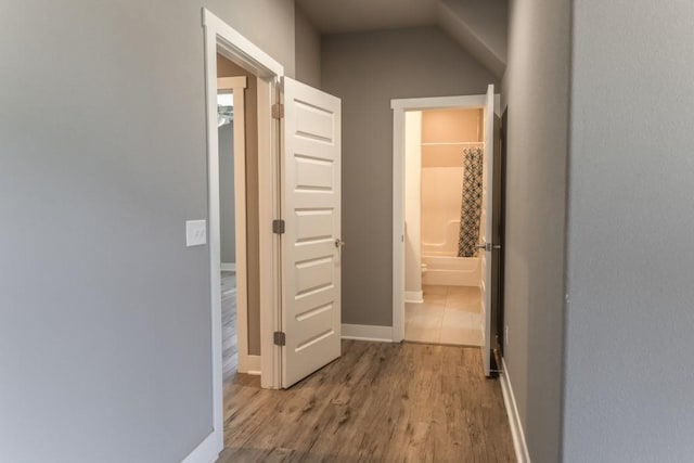 hall with hardwood / wood-style flooring