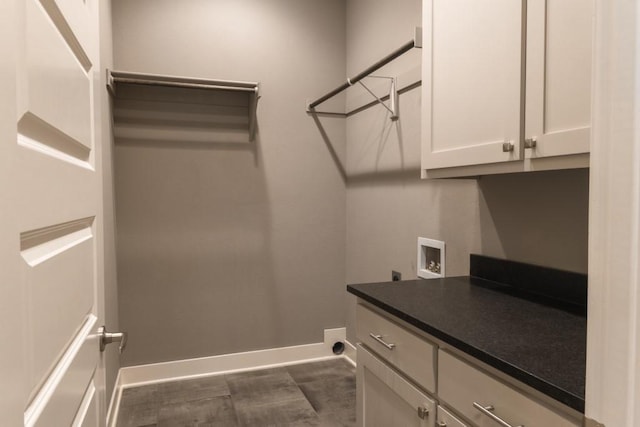 washroom featuring hookup for a washing machine, cabinets, and hookup for an electric dryer