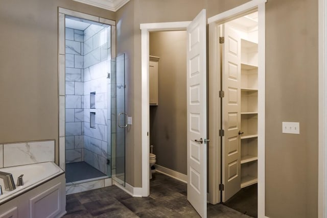 bathroom with toilet, a shower with door, and crown molding