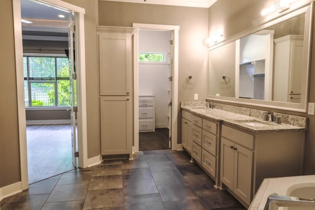 bathroom featuring vanity and ornamental molding