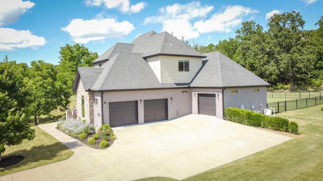 view of side of property with a garage and a yard