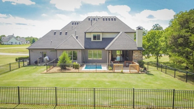 rear view of house featuring a swimming pool side deck and a yard