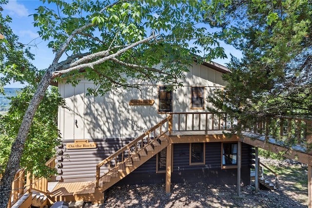 rear view of house featuring a wooden deck