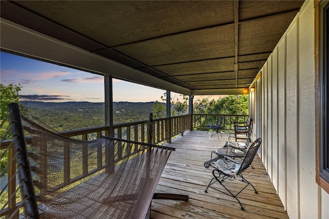 deck at dusk featuring a mountain view