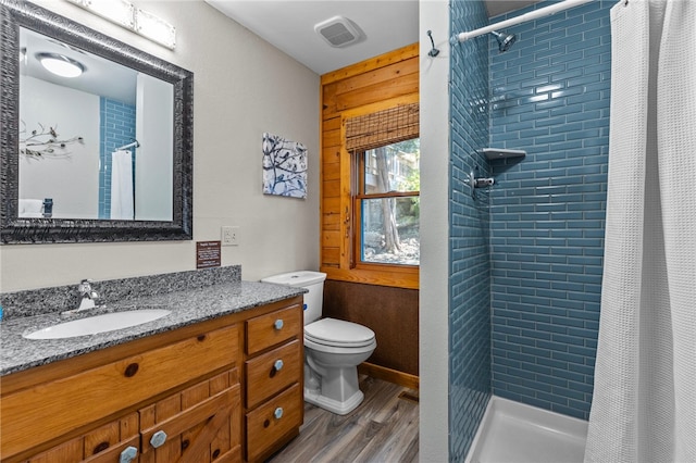 bathroom featuring a shower with curtain, hardwood / wood-style floors, toilet, and large vanity