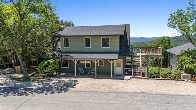 view of front facade with a deck with mountain view