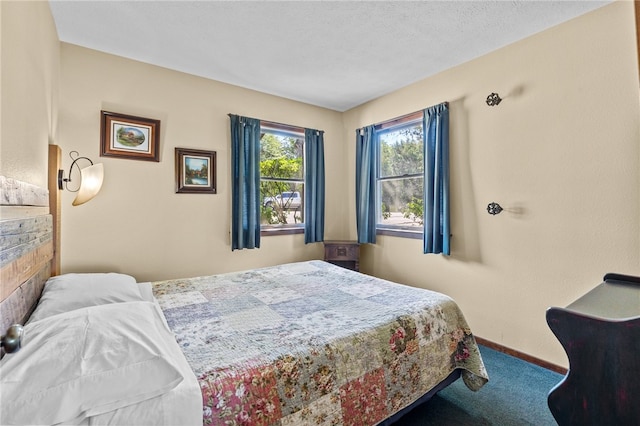 bedroom featuring carpet flooring and a textured ceiling