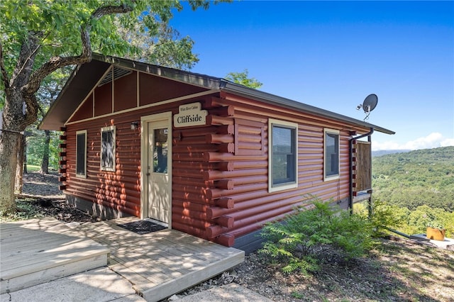 view of side of property featuring a wooden deck