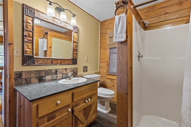 bathroom featuring wood-type flooring, wood walls, large vanity, and toilet