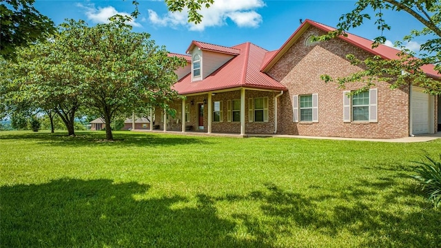 rear view of property featuring a lawn