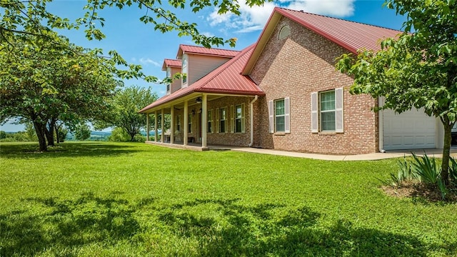 back of property with a porch, a garage, and a lawn