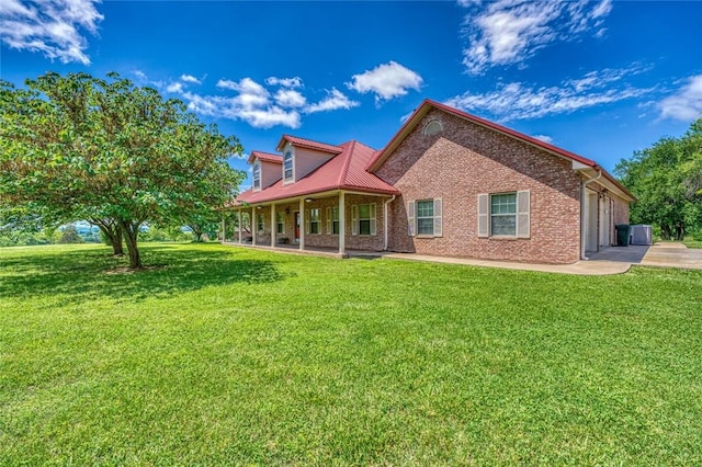 rear view of property featuring a lawn