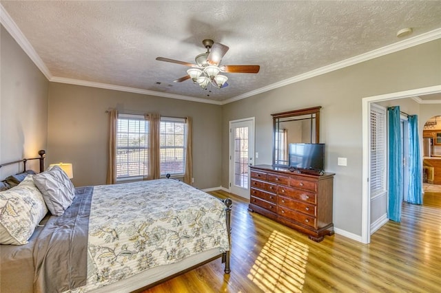 bedroom featuring a textured ceiling, ceiling fan, and crown molding