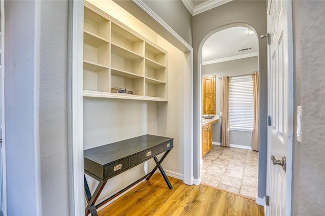 corridor featuring wood-type flooring and crown molding