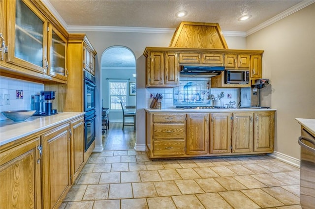 kitchen featuring stainless steel gas cooktop, decorative backsplash, light tile patterned flooring, and ornamental molding