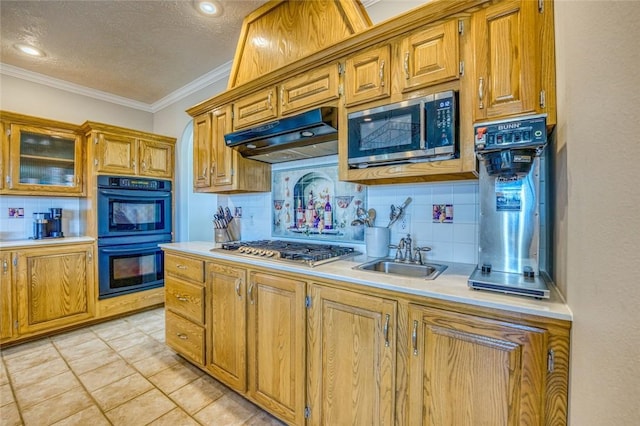 kitchen with sink, stainless steel appliances, a textured ceiling, decorative backsplash, and ornamental molding