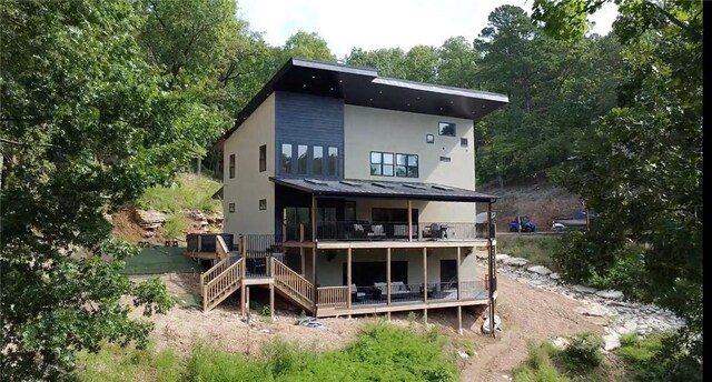 back of house featuring a balcony