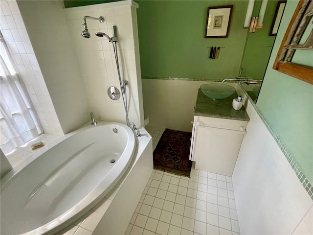 bathroom featuring tiled bath, vanity, tile walls, and tile floors