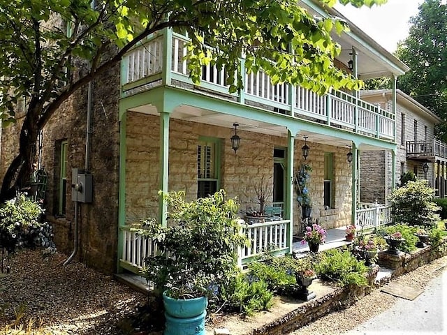 view of front of home with a balcony and a porch